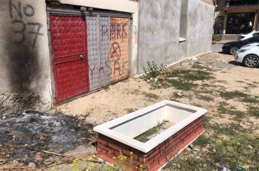Boş araziye bırakılmış isimli taşı bulunan mezar 