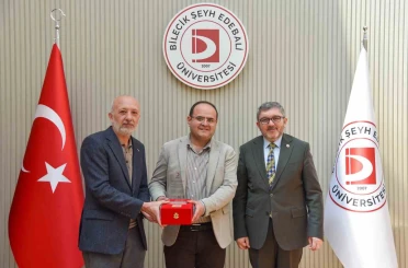 BŞEÜ’ye gümüş madalya ve madalya beratı takdimi 